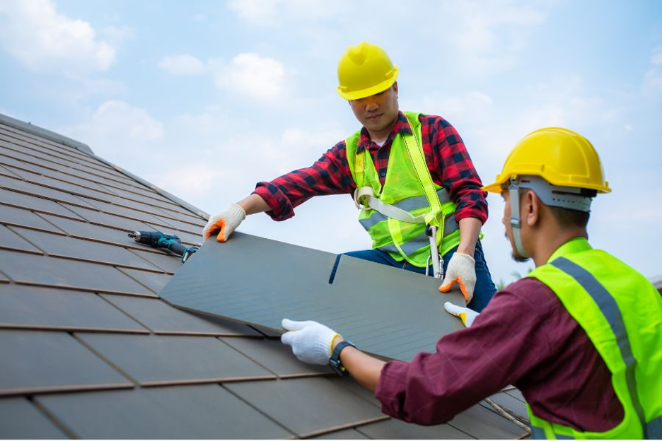 Roofing contractors repairing slate roofs